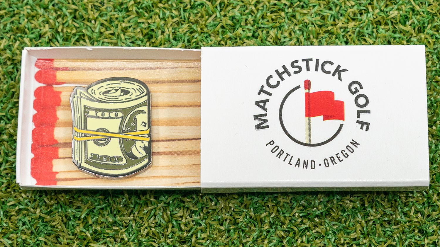 The first marker designed at the Neighborhood Golf Shop: the Cash Roll golf ball marker