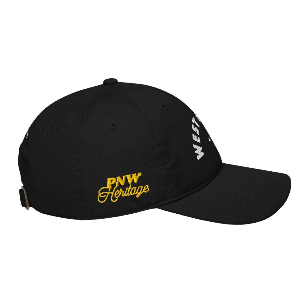 Black cap with &#39;PNW Heritage&#39; in yellow and &#39;WEST&#39; in white on a black background