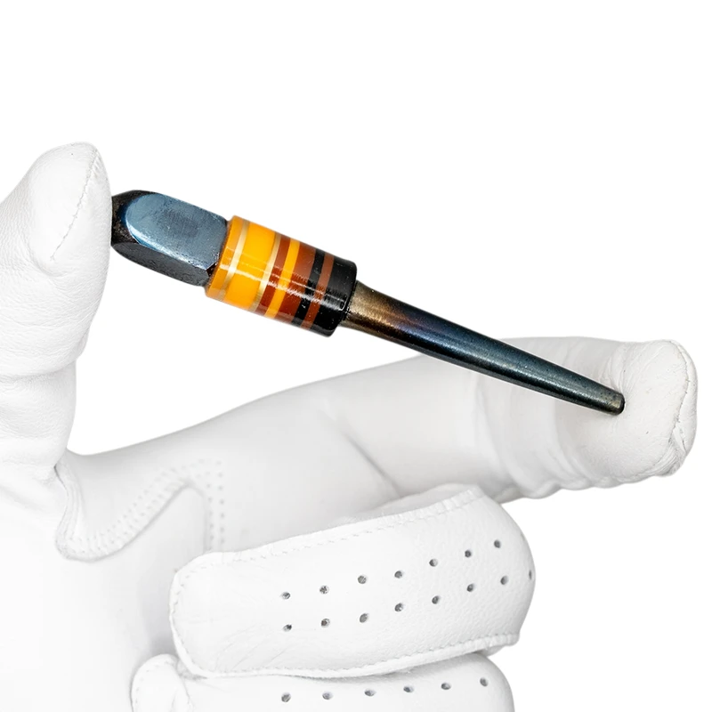 Stanley Punch Golf Divot Tool - Pinto in golf glove hand