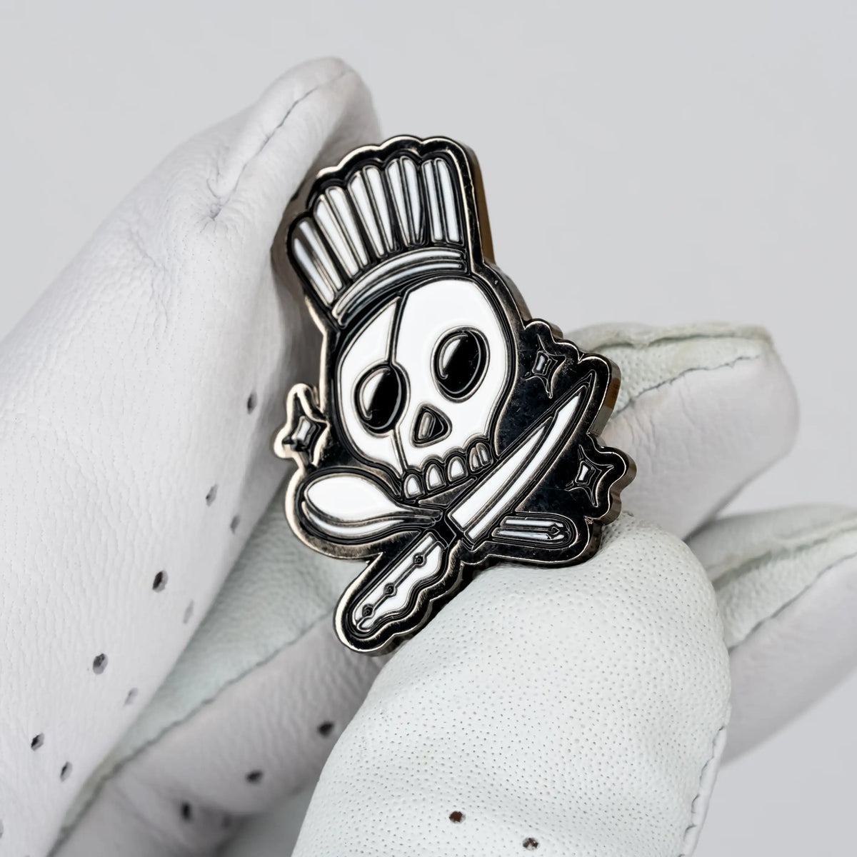 generous chef skull golf ball marker in glove