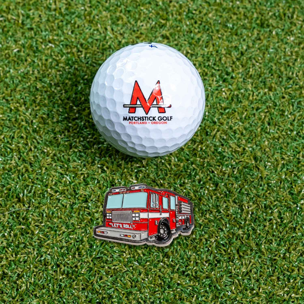 fire truck engine golf ball marker on grass with ball