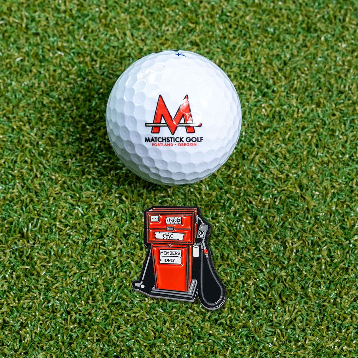 gas pump golf ball marker on grass with ball