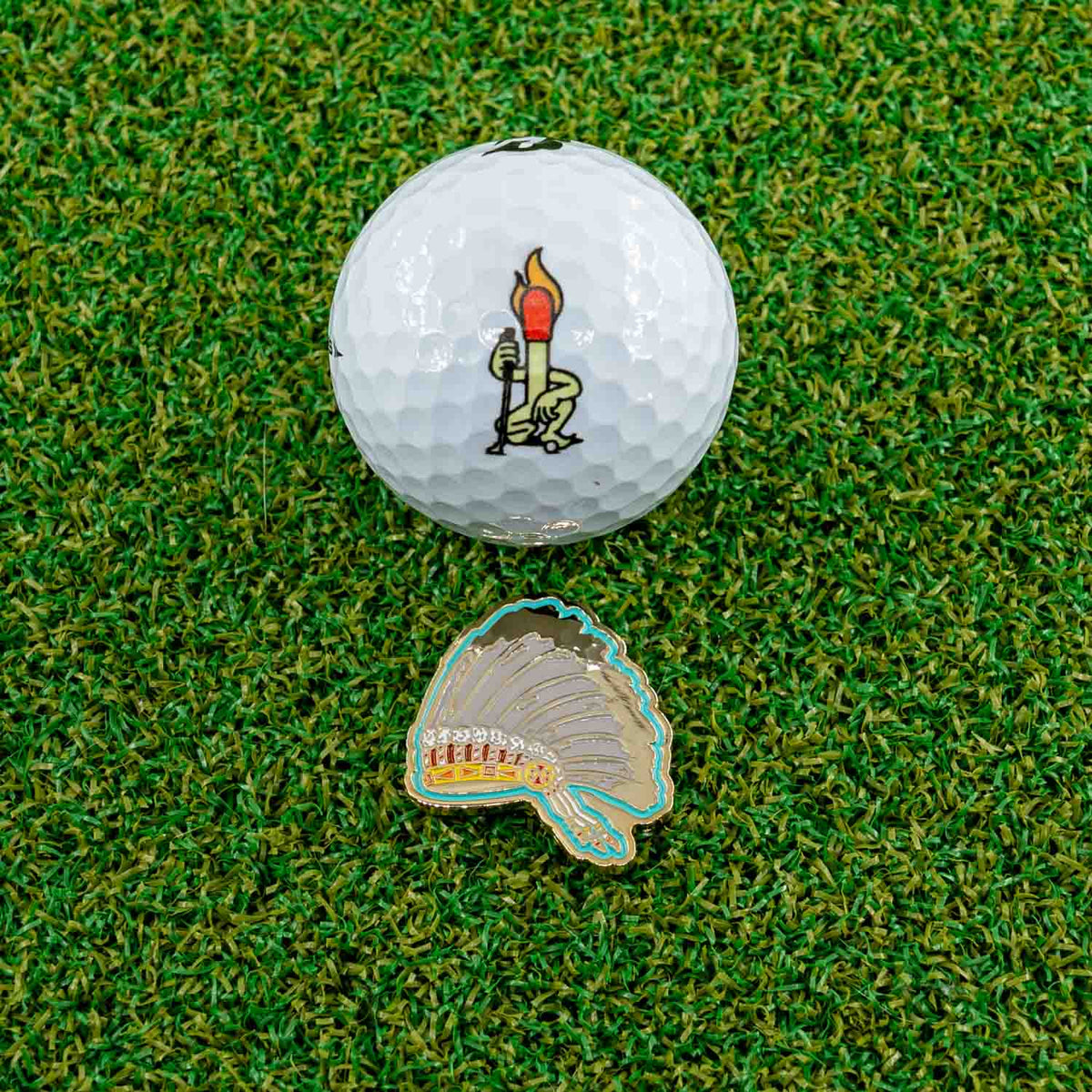 gold native indian headdress golf ball marker irene crowchild golf ball grass