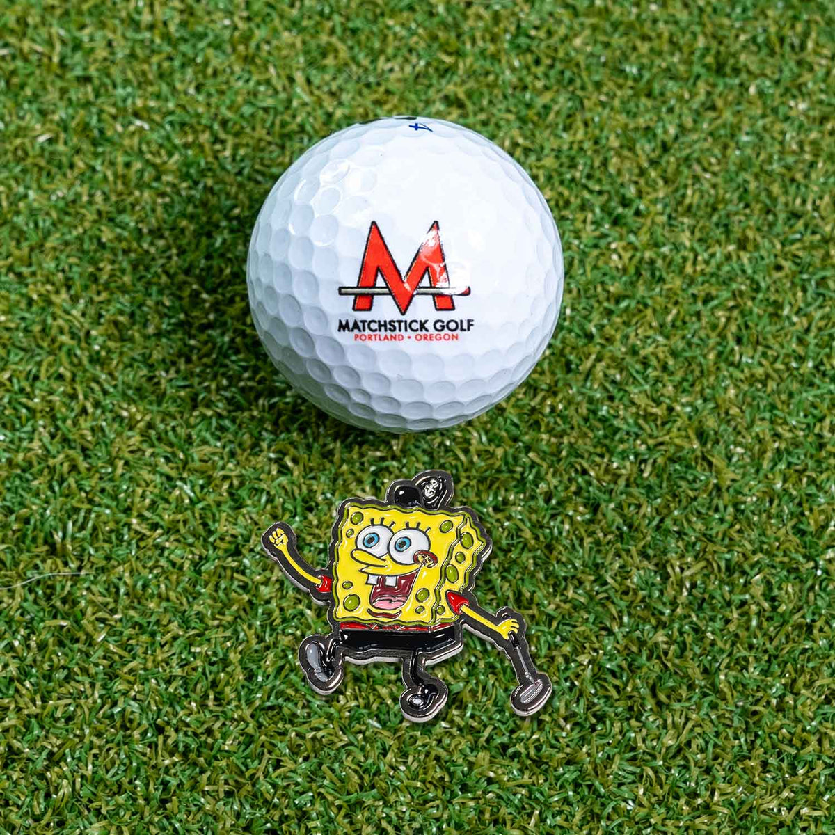 spongebob squarepants tiger woods golf ball marker on grass with ball