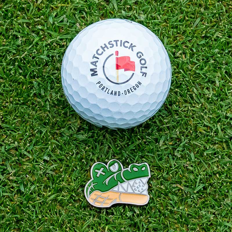 one eyed alligator happy gilmore chubbs golf ball marker with golf ball