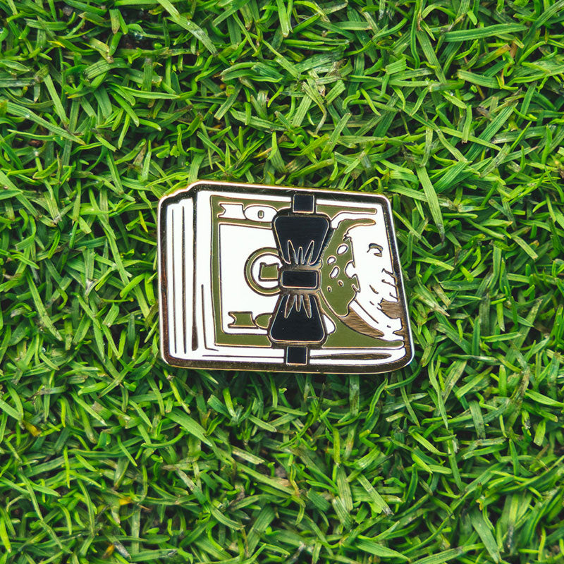bachelor party golf cash stack golf ball marker on grass