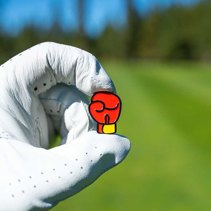 boxing glove golf ball marker held in golf glove