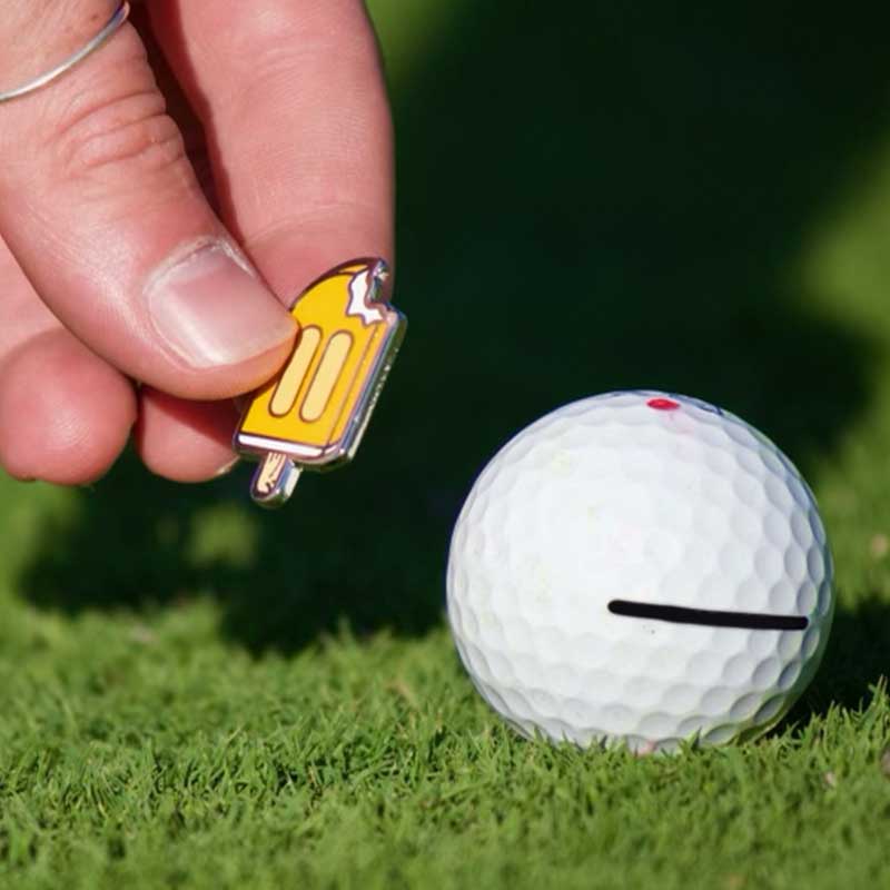 orange creamsicle golf ball marker marking golf ball