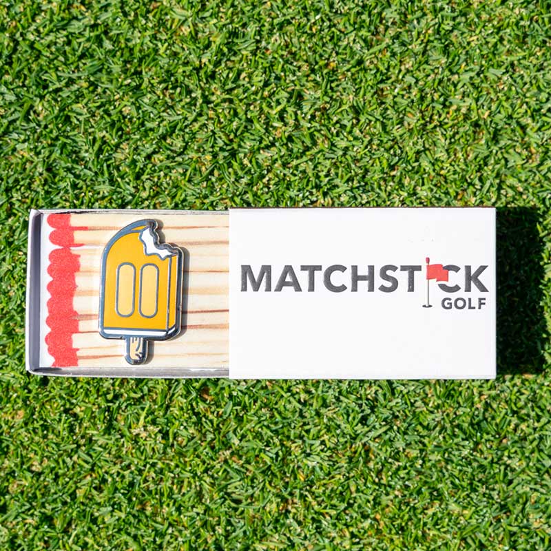 orange creamsicle golf ball marker in matchbox packaging
