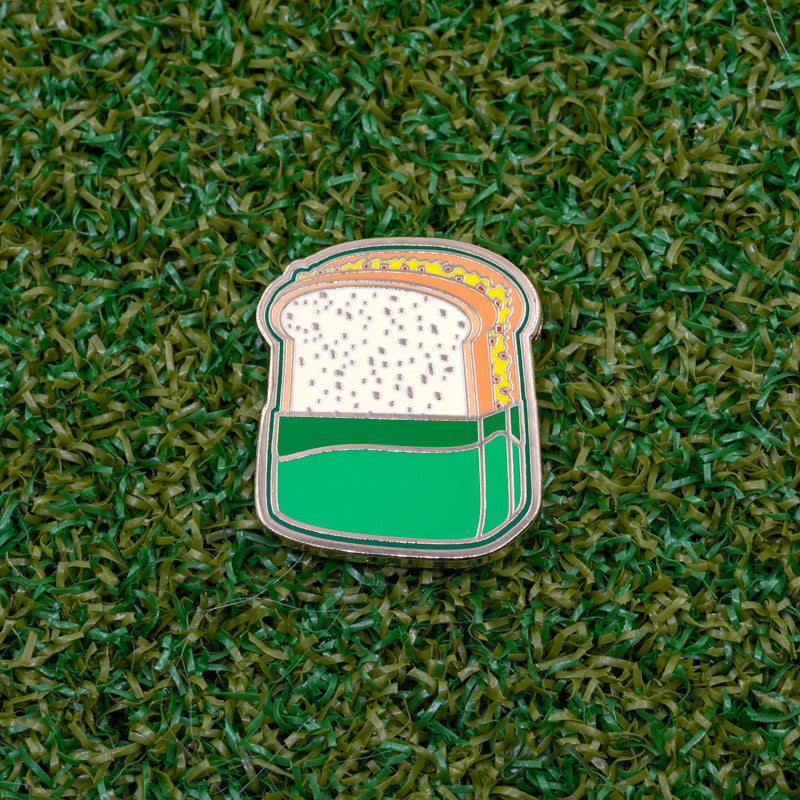 masters tournament golf pimento cheese sandwich golf ball marker on grass