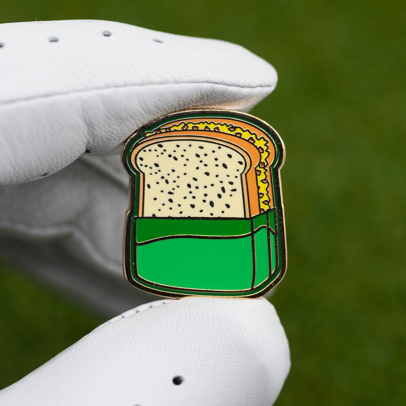 masters tournament golf pimento cheese sandwich golf ball marker in glove fingers