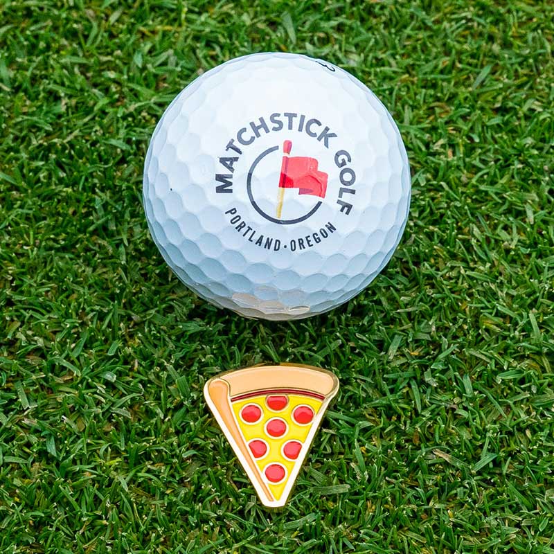 pepperoni pizza golf ball marker marking golf ball on green