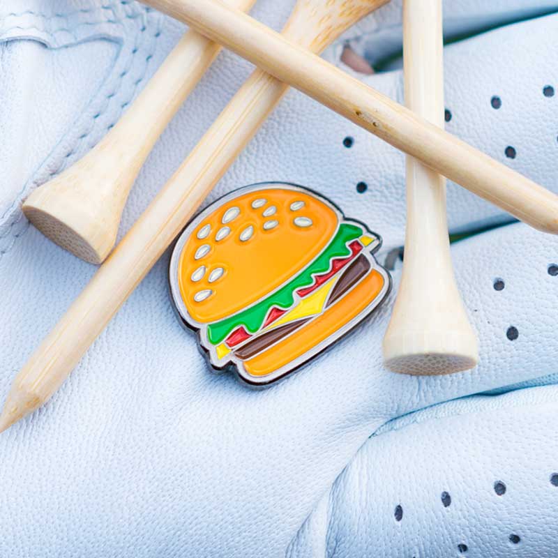 royale cheeseburger golf ball marker textured magnetic held in glove palm with golf tees