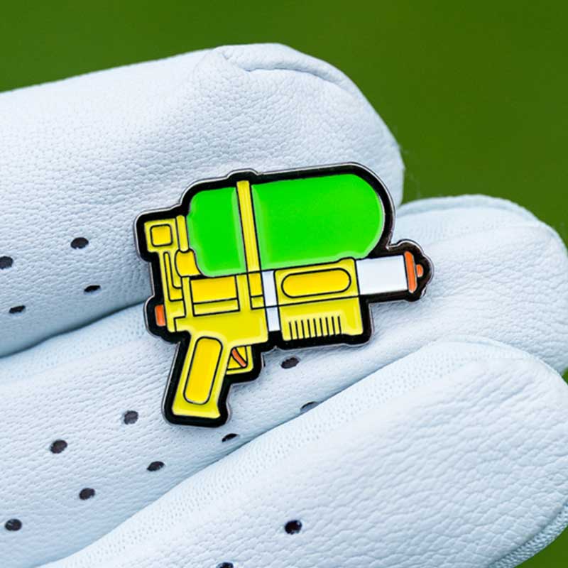 squirt gun golf ball marker in golf glove fingers
