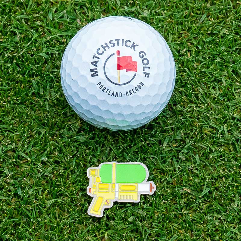 squirt gun golf ball marker marking golf ball