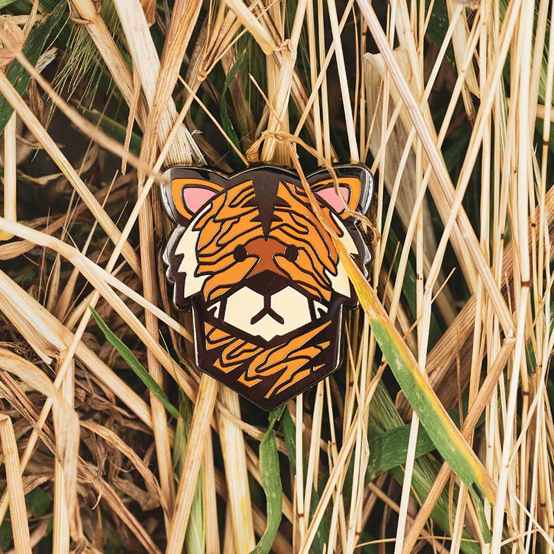 wood tiger golf ball marker in reeds and grass