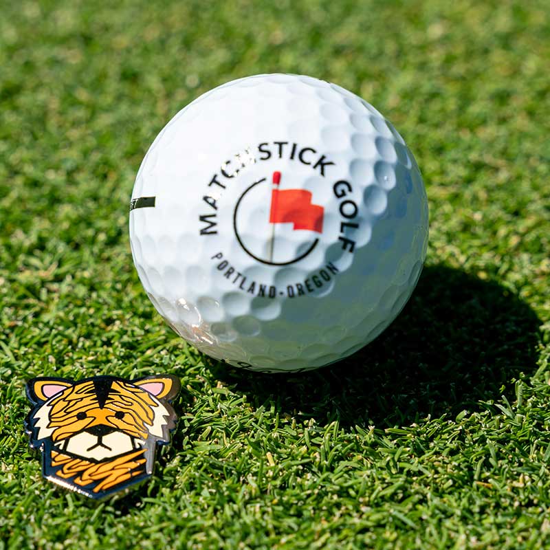 wood tiger golf ball marker marking golf ball