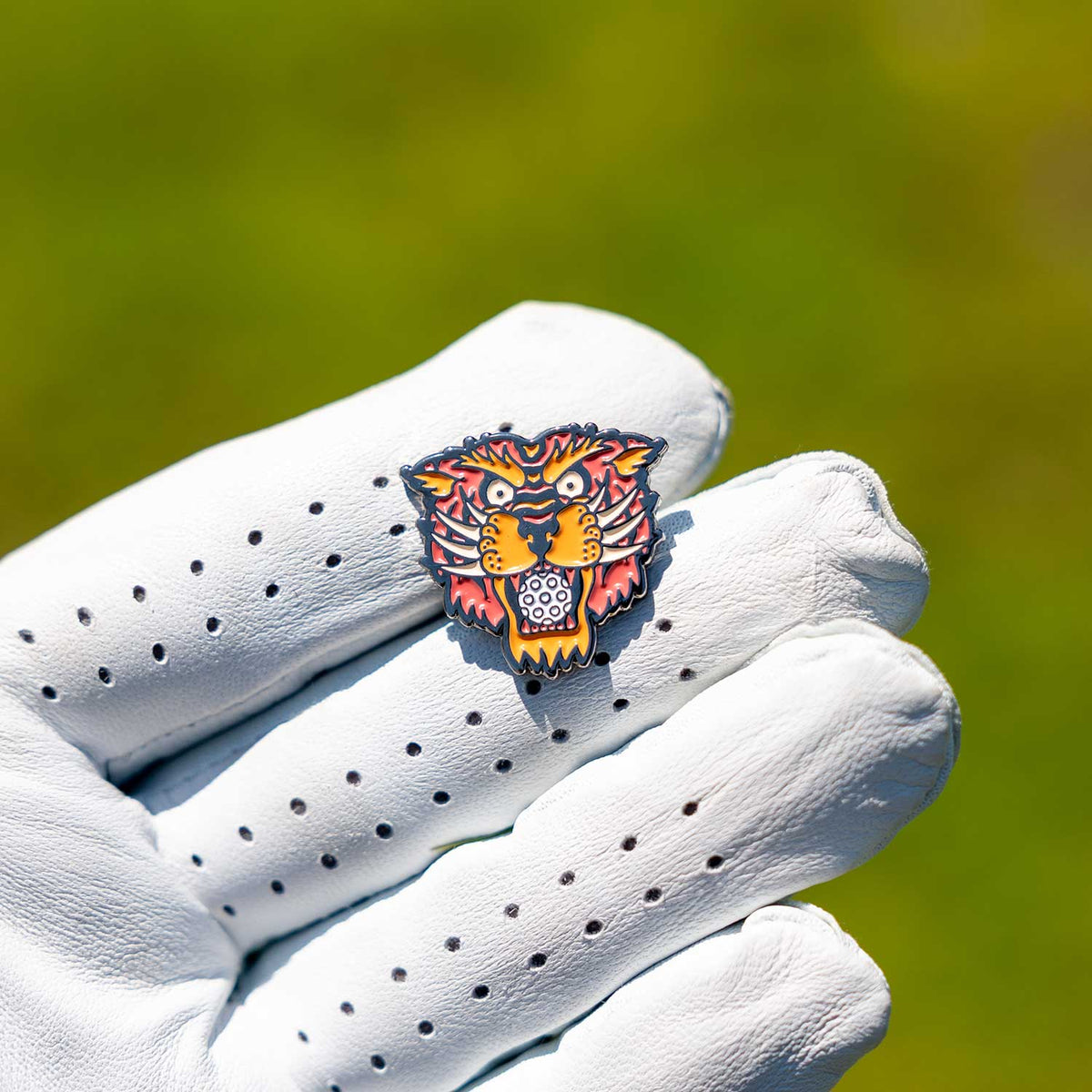 young dirty tiger head golf ball marker glove grass